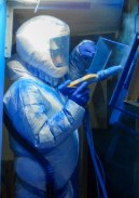 Operator applying electrostatic powder coating