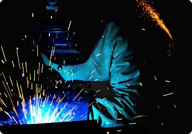 Welder at work with sparks